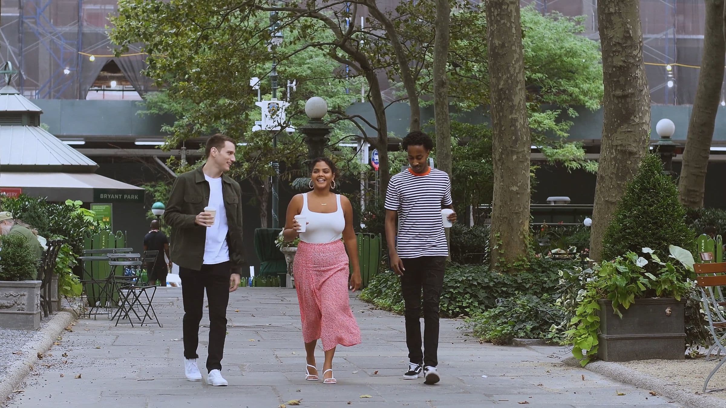 Friends walking together through a city in the evening.