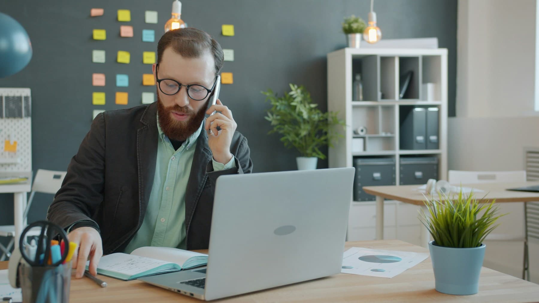 An advisor using a phone while preparing for a client meeting