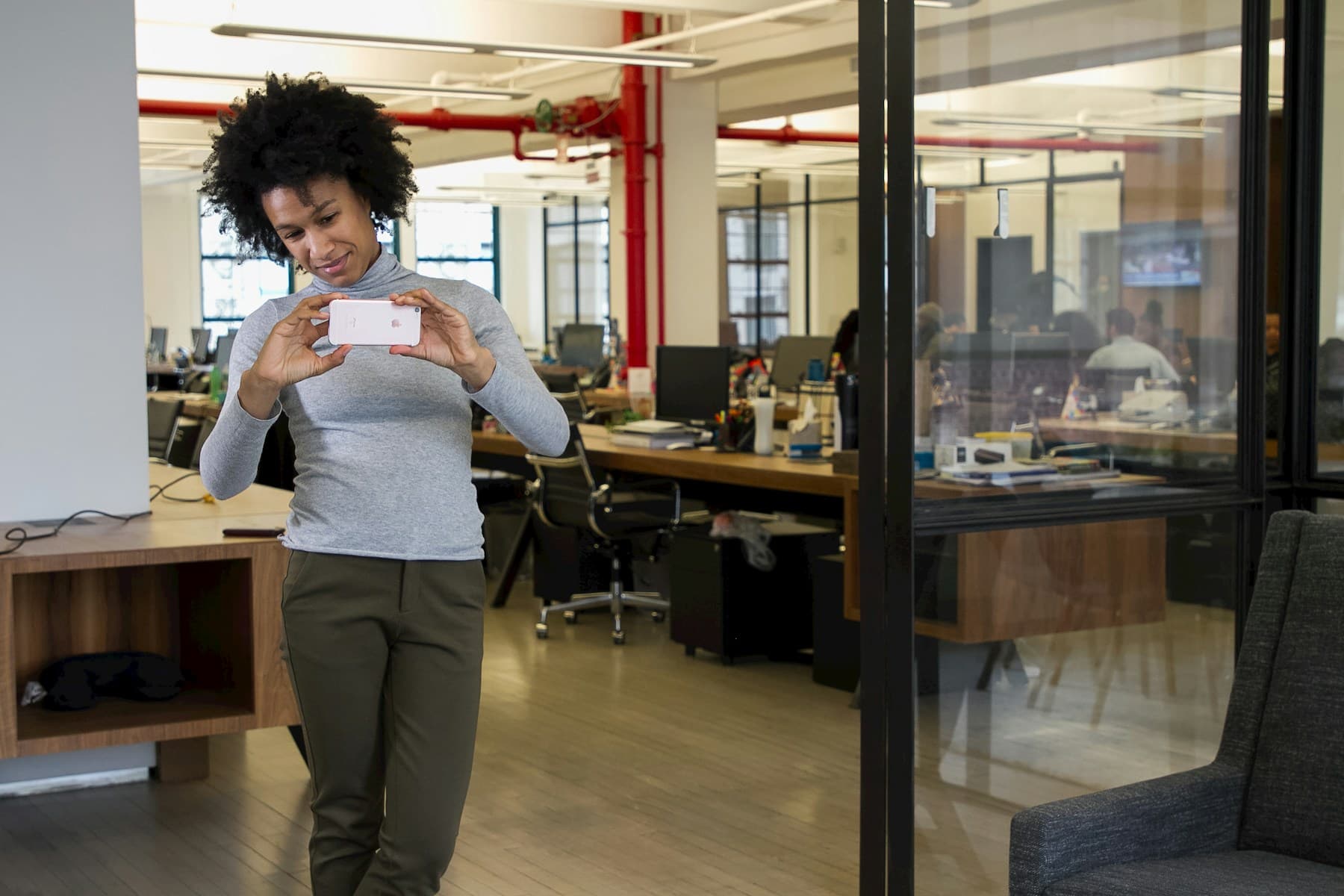 Professional using a phone while arriving at an office